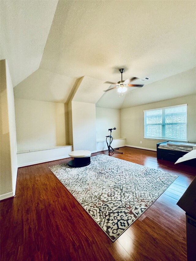 bonus room with hardwood / wood-style floors, ceiling fan, a textured ceiling, and vaulted ceiling