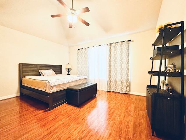 bedroom featuring lofted ceiling, hardwood / wood-style flooring, and ceiling fan