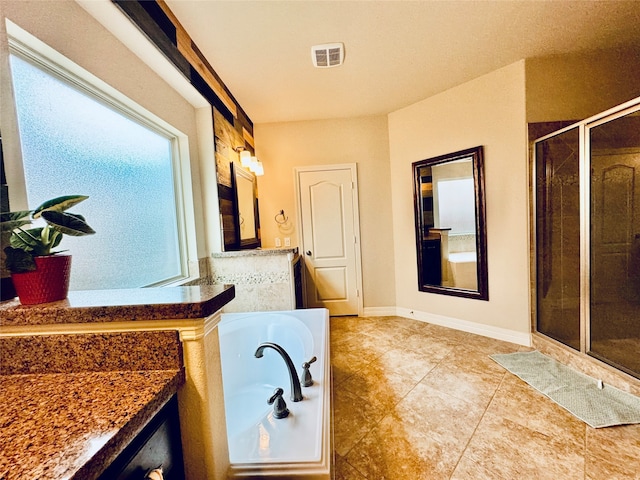 bathroom featuring independent shower and bath, vanity, and tile patterned flooring