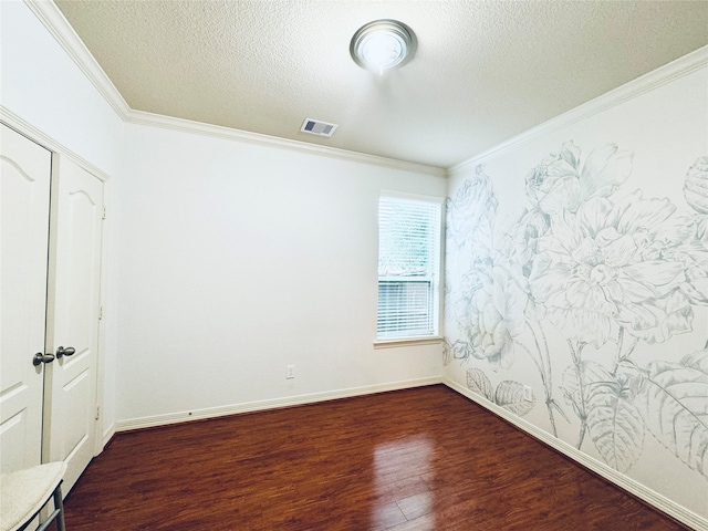 unfurnished room with dark hardwood / wood-style floors, a textured ceiling, and ornamental molding