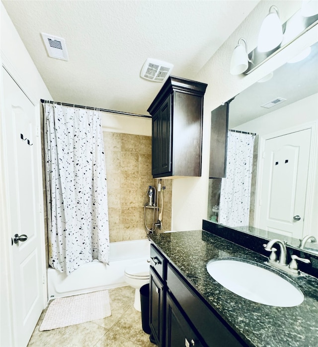 full bathroom featuring toilet, tile patterned flooring, a textured ceiling, vanity, and shower / tub combo