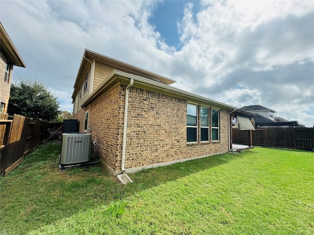 view of property exterior featuring cooling unit and a lawn