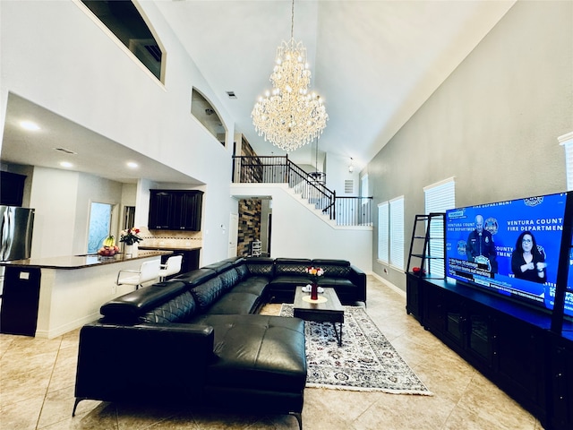 tiled living room with a high ceiling and an inviting chandelier