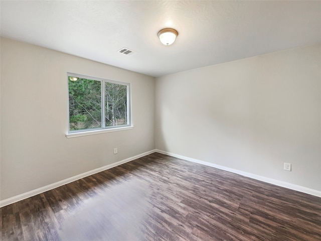 spare room with dark hardwood / wood-style flooring