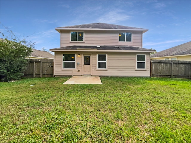 rear view of property with a lawn and a patio area