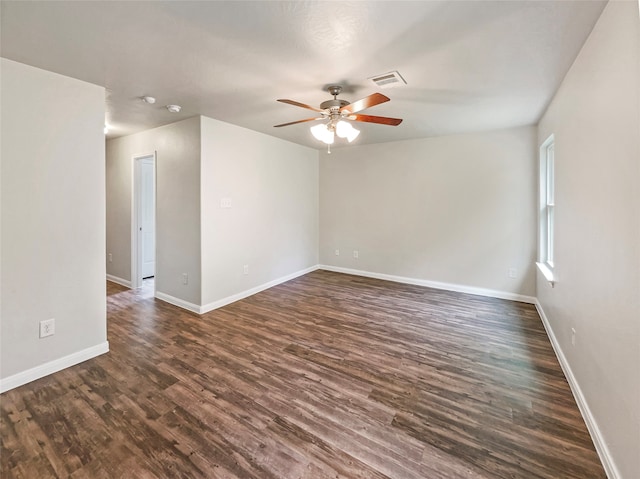 unfurnished room featuring dark wood-type flooring and ceiling fan