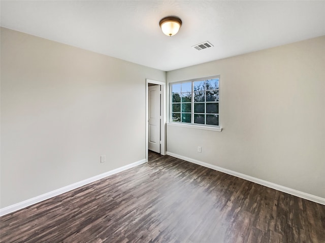 unfurnished room featuring dark hardwood / wood-style flooring