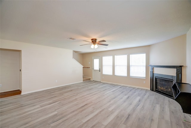 unfurnished living room featuring light hardwood / wood-style floors and ceiling fan