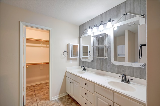 bathroom featuring vanity, a textured ceiling, and tile patterned floors