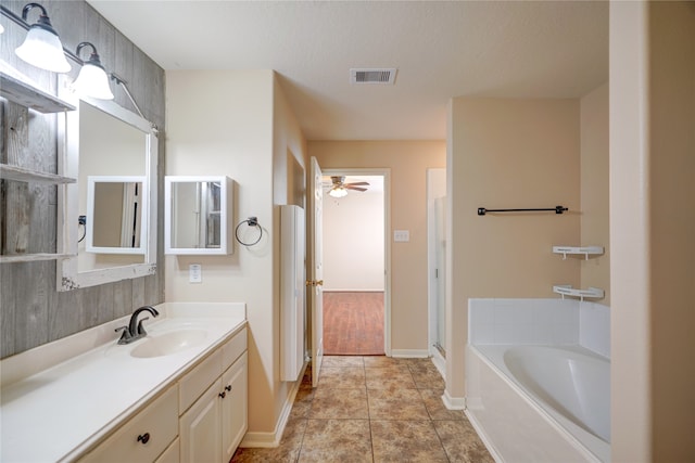 bathroom with tile patterned floors, a textured ceiling, vanity, ceiling fan, and independent shower and bath