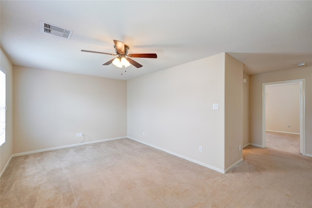 unfurnished room with a healthy amount of sunlight, light carpet, and ceiling fan