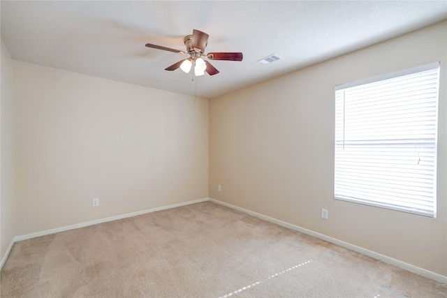 unfurnished room featuring ceiling fan and light colored carpet