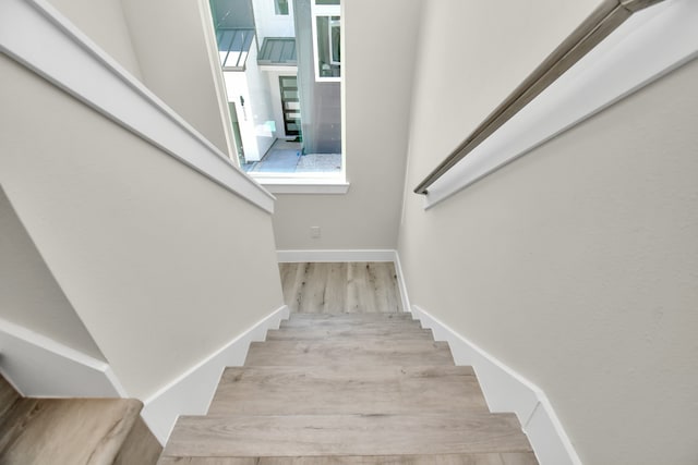 staircase with hardwood / wood-style floors