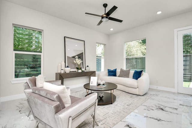 living room with ceiling fan and a healthy amount of sunlight