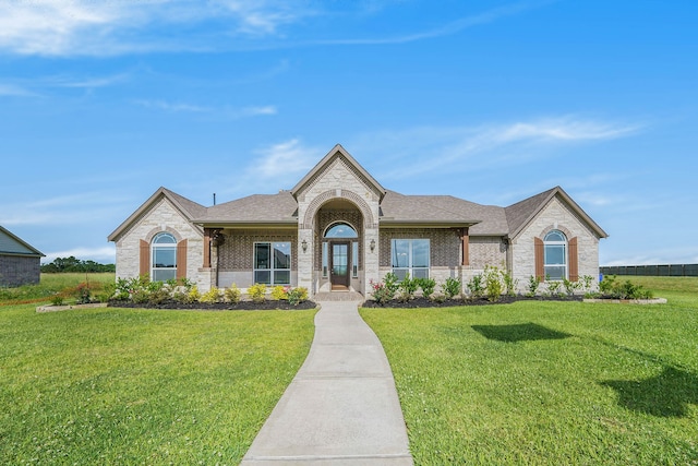 ranch-style home featuring a front lawn