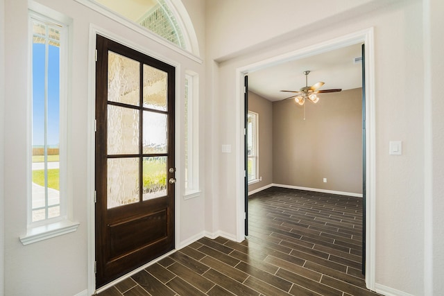 foyer entrance with dark wood-type flooring and ceiling fan