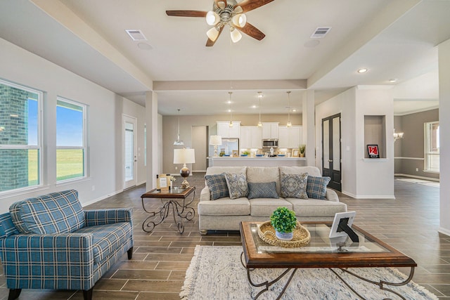 living room featuring dark hardwood / wood-style flooring and ceiling fan