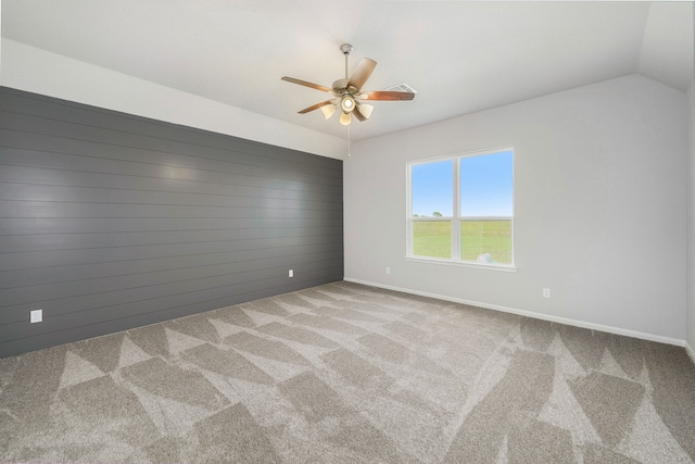 spare room with ceiling fan, light carpet, and lofted ceiling