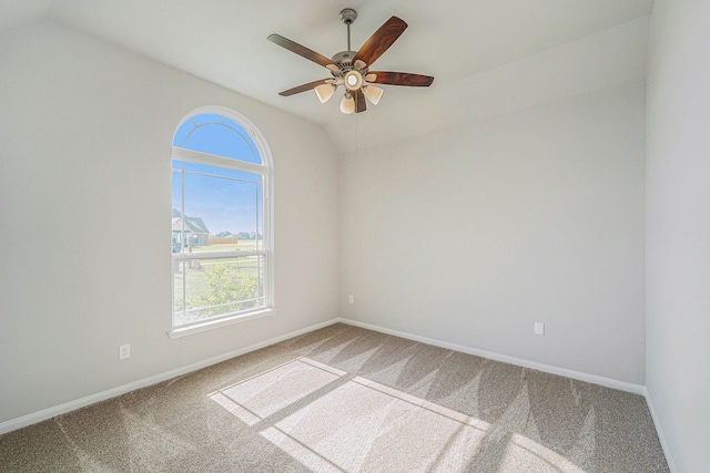 unfurnished room with carpet, vaulted ceiling, and ceiling fan