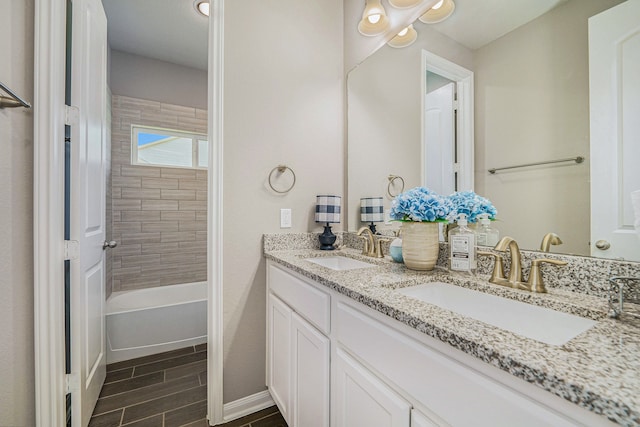 bathroom with vanity and tiled shower / bath combo