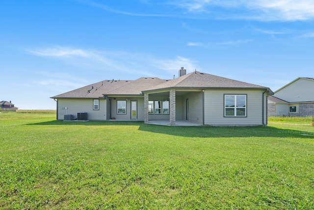 back of house featuring a yard and a patio area