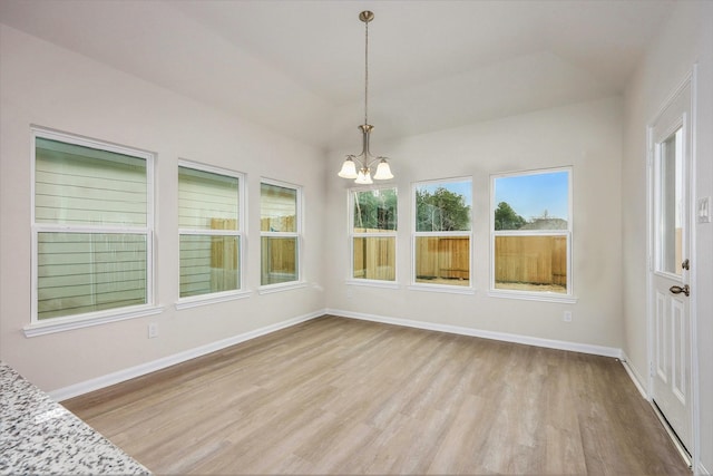 unfurnished sunroom with an inviting chandelier