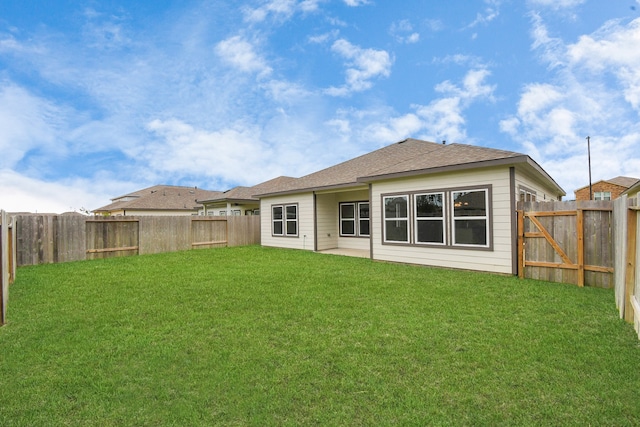 rear view of property with a lawn