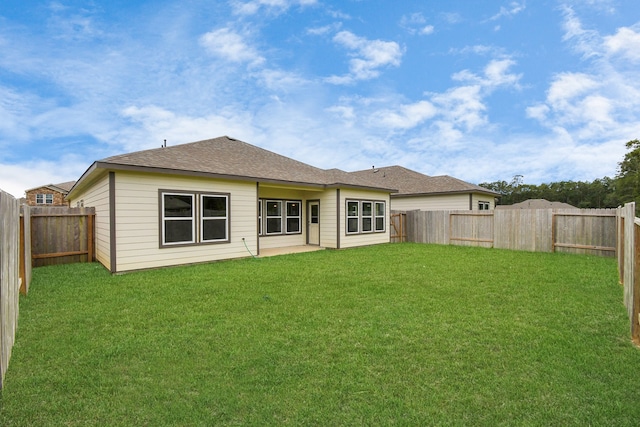 rear view of property with a lawn