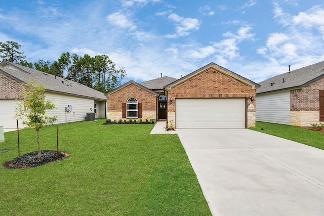 ranch-style home with central air condition unit, a garage, and a front yard