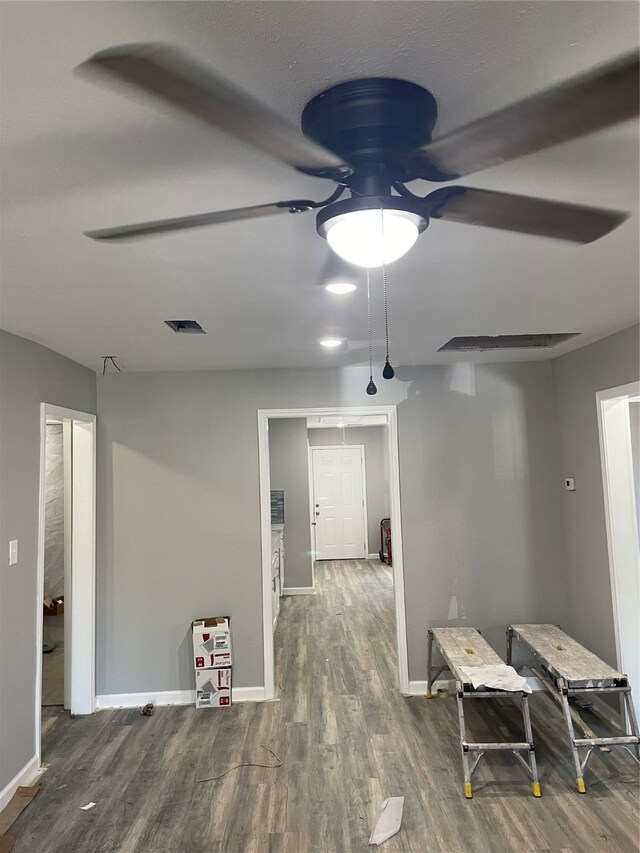 hallway with hardwood / wood-style flooring