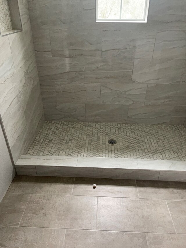 bathroom with a tile shower