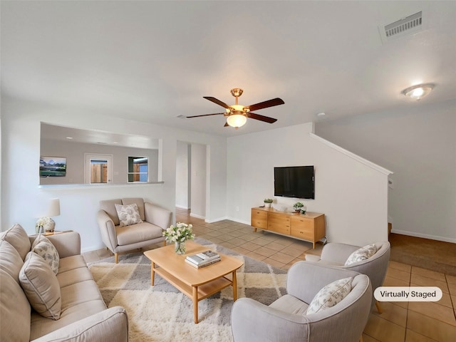 tiled living room with ceiling fan