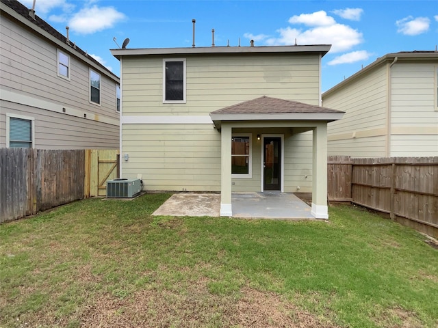 rear view of property with central AC, a yard, and a patio area