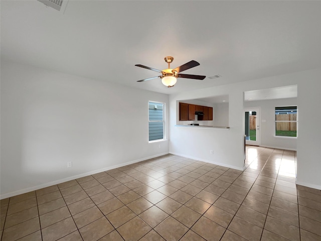 empty room featuring light tile patterned floors and ceiling fan