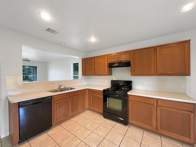 kitchen with black appliances, sink, and light tile patterned floors