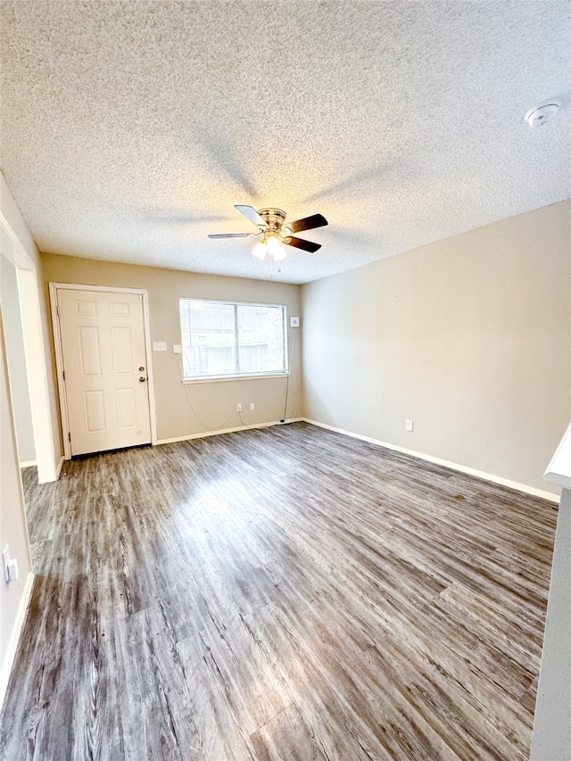 spare room featuring ceiling fan, wood-type flooring, and a textured ceiling