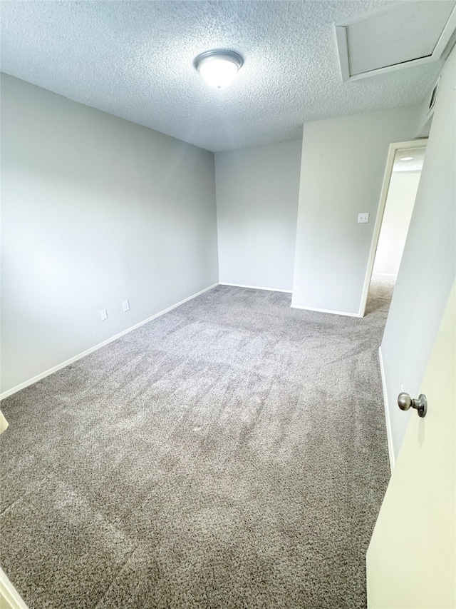 carpeted spare room with a textured ceiling