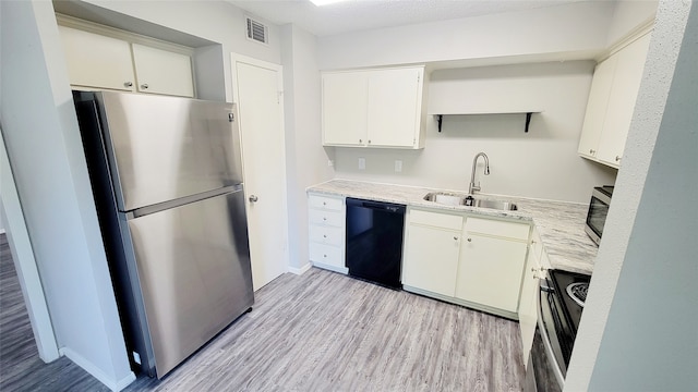 kitchen with white cabinetry, sink, stainless steel appliances, and light wood-type flooring