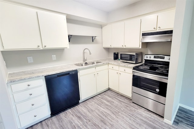 kitchen with white cabinets, light wood-type flooring, stainless steel appliances, and sink