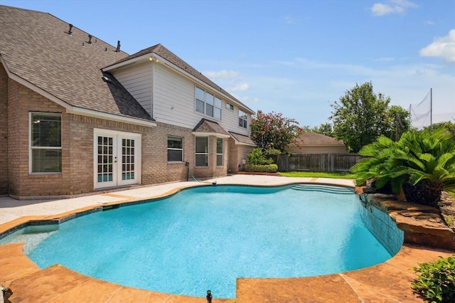 view of swimming pool with french doors