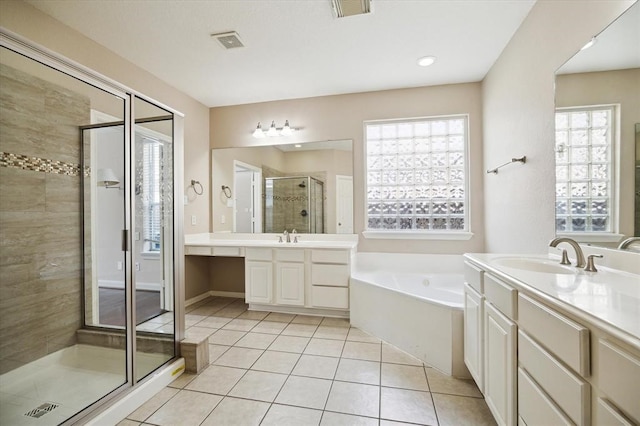 bathroom featuring tile patterned flooring, vanity, a healthy amount of sunlight, and shower with separate bathtub