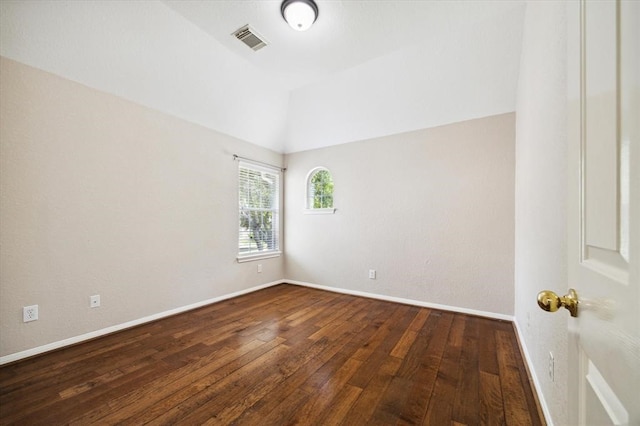 spare room featuring hardwood / wood-style flooring and lofted ceiling