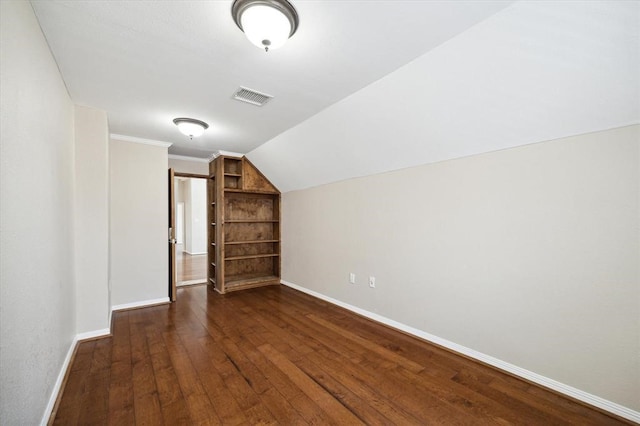 additional living space with dark hardwood / wood-style floors and vaulted ceiling