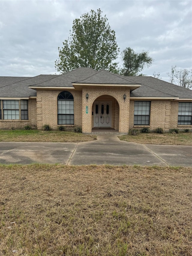 617 County Road 99, Alvin, TX 77511 - view of front of property featuring brick siding, roof with shingles, and concrete driveway