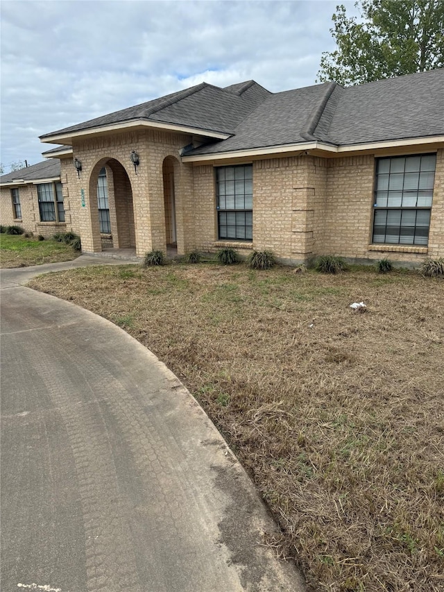 617 County Road 99, Alvin, TX 77511 - view of front of home with brick siding and a shingled roof
