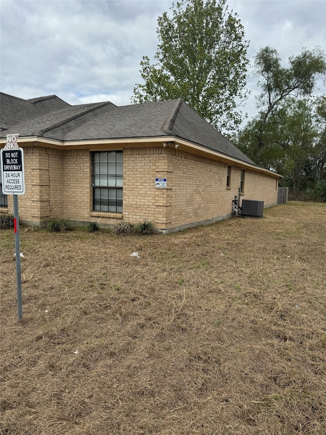 view of side of home featuring central AC unit