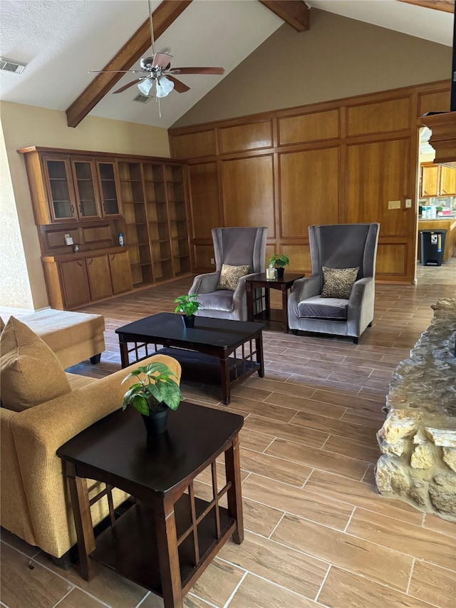 living room featuring vaulted ceiling with beams and ceiling fan