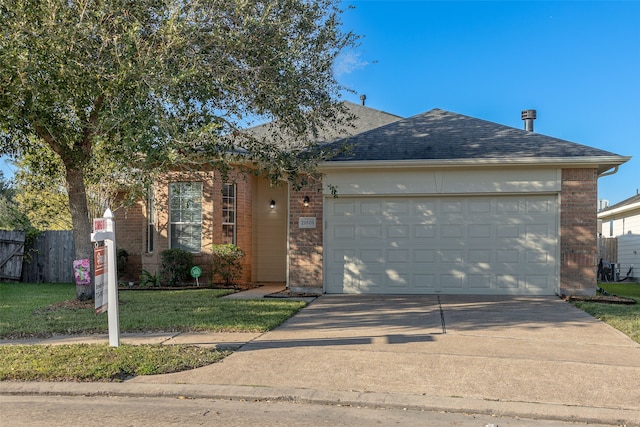 view of front of property featuring a front yard and a garage