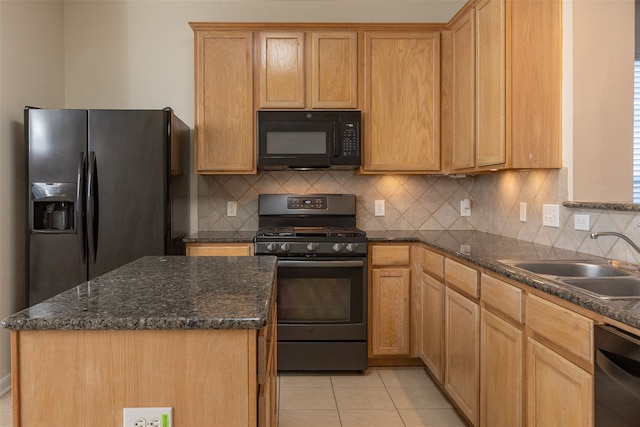 kitchen featuring decorative backsplash, sink, black appliances, light tile patterned floors, and a center island