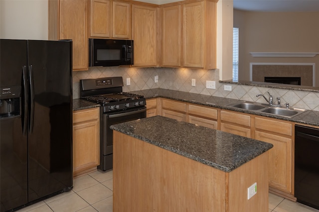 kitchen with decorative backsplash, sink, black appliances, light tile patterned floors, and a center island